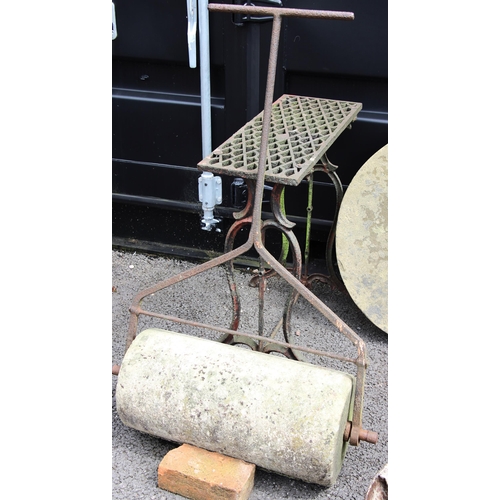 1100 - A wrought iron and sandstone garden roller, 60cm W, along with a cast iron sewing machine stand, 74c... 