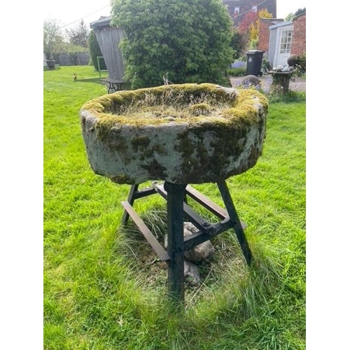 1101 - A circular sandstone trough, with associated painted iron stand, 25cm H x 83cm D