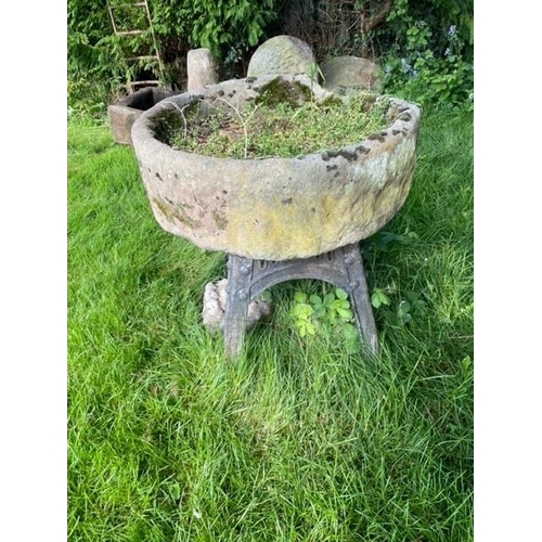 1102 - A circular sandstone trough, with associated painted iron stand, 26cm H x 82cm D