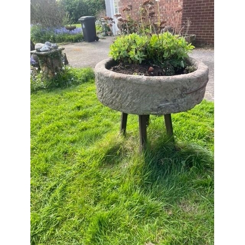 1103 - A circular sandstone trough, with associated painted iron stand, 29cm H x 90cm D