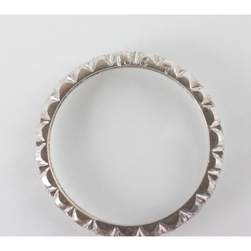 176 - A diamond set full eternity ring, the continuous round cut diamonds within white metal shank, open t... 