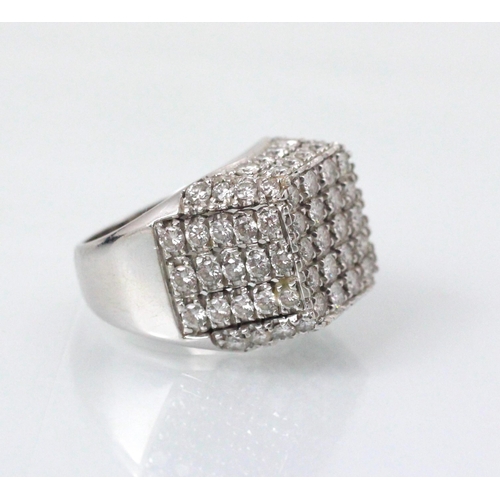 177 - An Italian white gold diamond set cocktail ring, the square shaped head with round cut diamonds set ... 