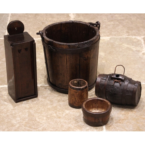 852 - An 18th century oak candle box, possibly Welsh, the rounded and pierced pediment over the chamfered ... 