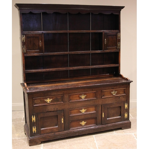 917 - A George III Conwy Valley oak dresser, the enclosed plate rack with a moulded cornice and wavy friez... 