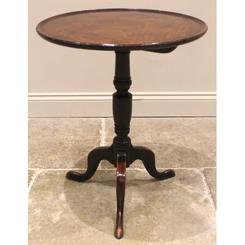 925 - A George III  mahogany tray top tripod table, the circular top with a moulded raised rim, upon a rin... 