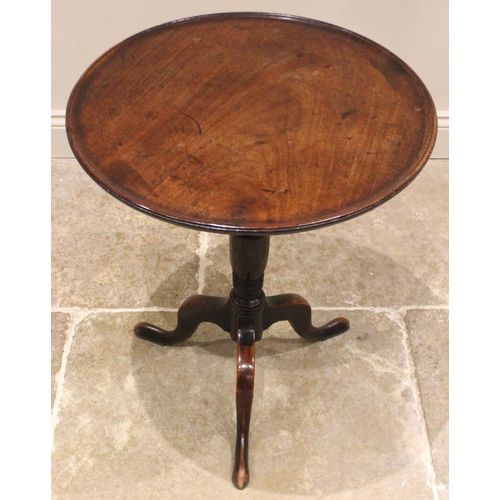 925 - A George III  mahogany tray top tripod table, the circular top with a moulded raised rim, upon a rin... 