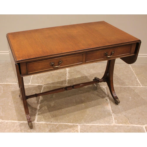 929 - A Regency style mahogany sofa table, late 20th century, the rectangular drop leaf top with rounded c... 