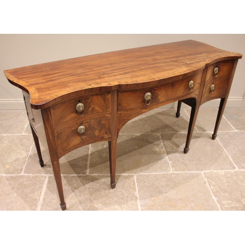 930 - A George III Sheraton style mahogany sideboard, the serpentine crossbanded top over a central silver... 