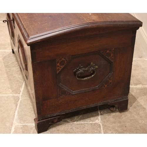 931 - An early 19th century German oak, walnut and marquetry domed marriage chest, the hinged cover openin... 