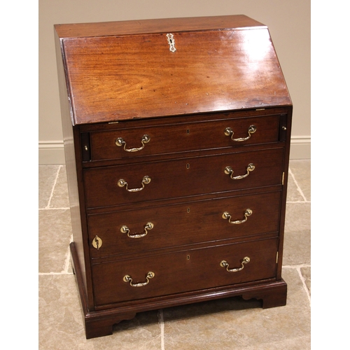 934 - A George III mahogany bureau, the fall front opening to a single drawer and pigeon holes, over a fau... 