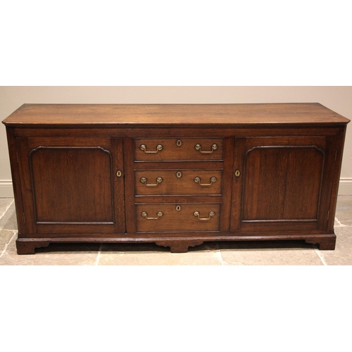 936 - A 19th century oak dresser base, the rectangular top with canted front corners over a central bank o... 