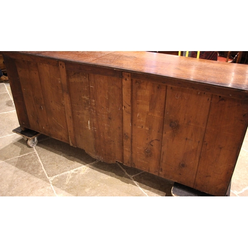 936 - A 19th century oak dresser base, the rectangular top with canted front corners over a central bank o... 