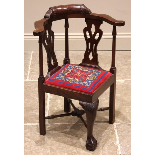 937 - A Chippendale revival child's mahogany corner chair, early 20th century, the curved top rail upon a ... 