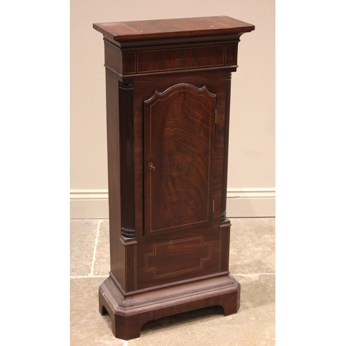 938 - A George III mahogany side cabinet, converted from a longcase clock case, the shaped door outlined w... 