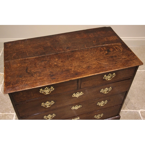 940 - A George II oak chest of drawers, the slightly oversailing top above an arrangement of two short and... 