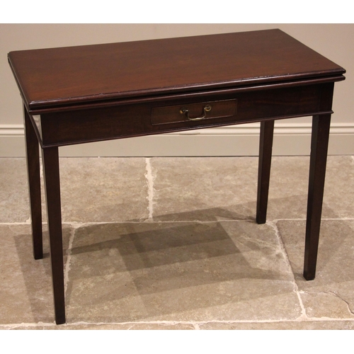 941 - A George III mahogany tea table, the folding rectangular top over a single oak lined drawer, upon le... 