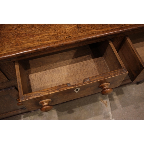 942 - A late George III Welsh honey oak dresser, the plate rack with a moulded cornice and three shelves, ... 