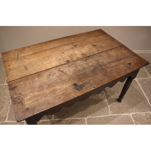 943 - A 19th century provincial oak kitchen or work table, probably Welsh, the rectangular plank top over ... 