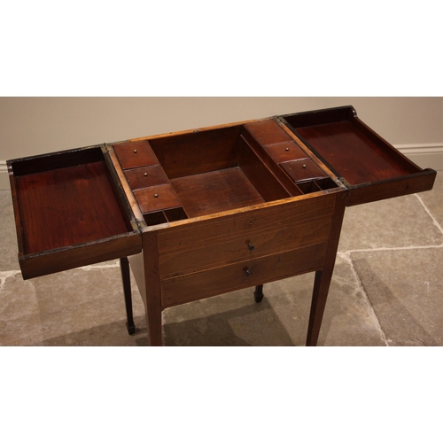 945 - A George III mahogany and tulip wood cross banded work table, the twin hinged covers opening to an a... 