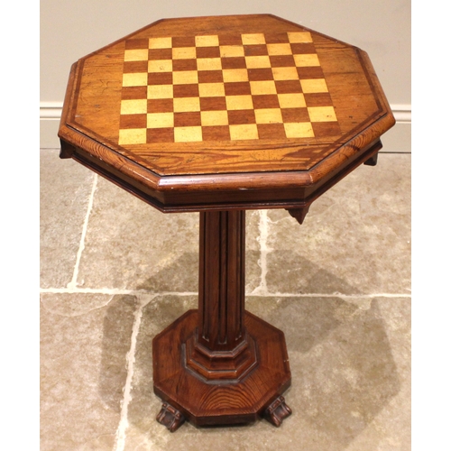 952 - A Victorian pitch pine pedestal games table, the moulded octagonal top inlaid with a chequered games... 