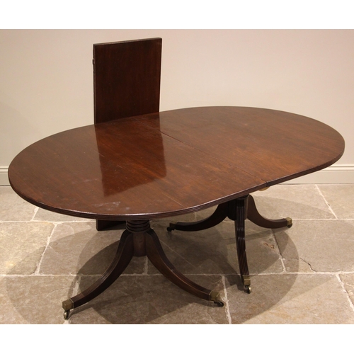 953 - A 19th century and later twin pedestal mahogany dining table, the oval table with a reeded edge upon... 