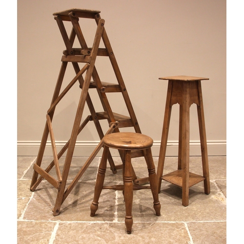 963 - A Victorian ash and elm Boston stool, the gently dished seat upon four ring turned and tapering legs... 