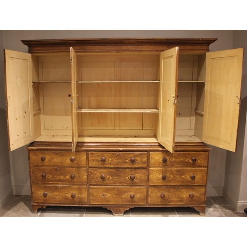 986 - A Victorian scumbled pine housekeepers cupboard, the moulded cornice over a central pair of cupboard... 