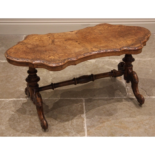 987 - A Victorian walnut centre table, later reduced, the shaped and figured book veneered top inlaid with... 