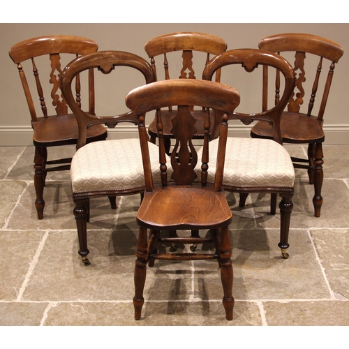 994 - A matched set of four Victorian elm and beech wood kitchen chairs, each with a pierced splat over a ... 