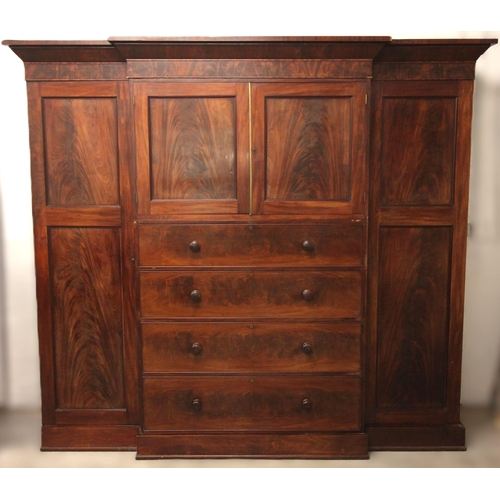 998 - A Victorian flame mahogany breakfront compactum wardrobe, the cavetto cornice over a projected centr... 