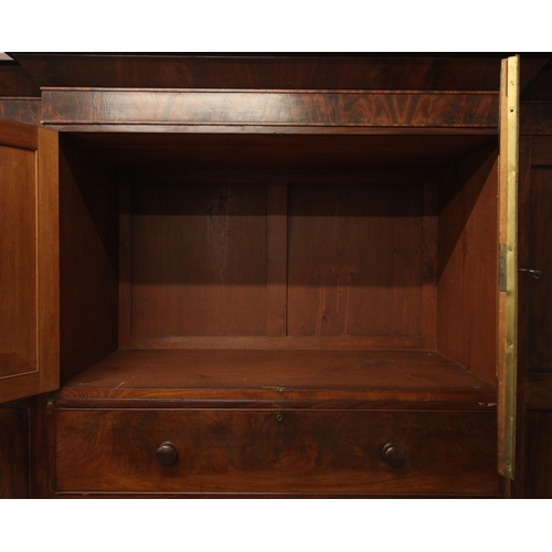 998 - A Victorian flame mahogany breakfront compactum wardrobe, the cavetto cornice over a projected centr... 