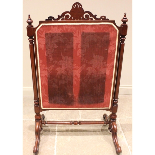 1015 - A Victorian mahogany framed stump work cheval firescreen, the open work scroll crest centred with a ... 