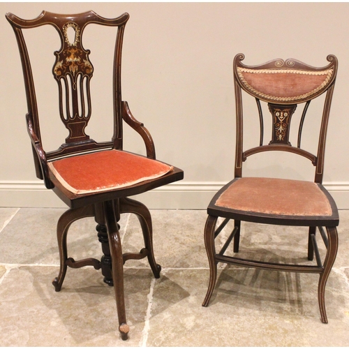 1020 - An Edwardian inlaid mahogany revolving music chair, the pierced and foliate inlaid splat back extend... 