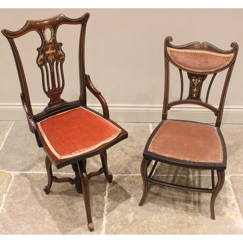 1020 - An Edwardian inlaid mahogany revolving music chair, the pierced and foliate inlaid splat back extend... 