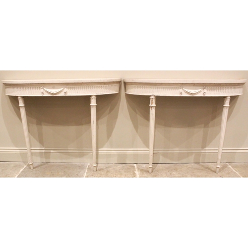 1022 - A pair of painted console hall tables, in the manner of Robert Adam, early 20th century, each of dem... 