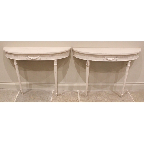 1022 - A pair of painted console hall tables, in the manner of Robert Adam, early 20th century, each of dem... 