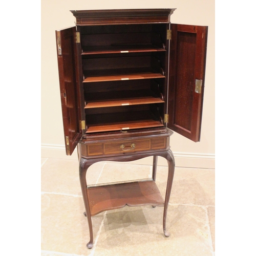 1023 - An Edwardian mahogany and satinwood banded music cabinet on stand, the moulded cornice with canted f... 