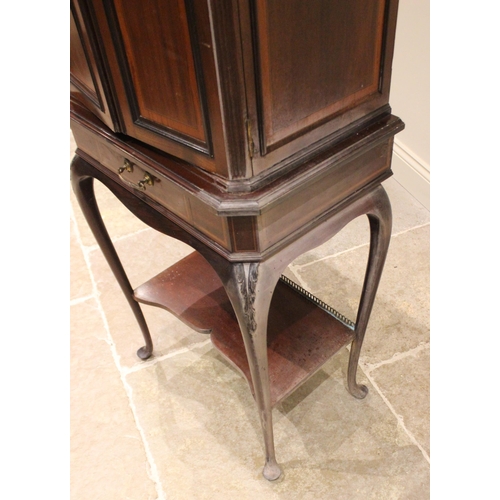 1023 - An Edwardian mahogany and satinwood banded music cabinet on stand, the moulded cornice with canted f... 