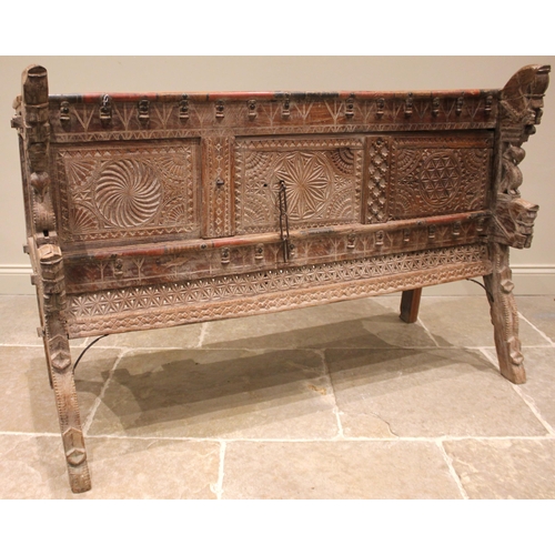 1030 - A Rajasthani hardwood dowry chest, 20th century, the geometric incised frieze applied with turned ha... 