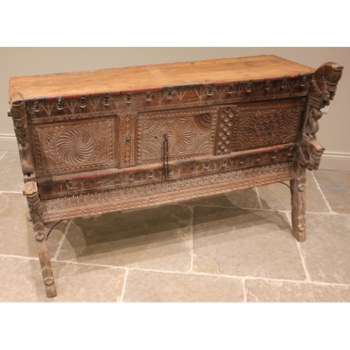 1030 - A Rajasthani hardwood dowry chest, 20th century, the geometric incised frieze applied with turned ha... 