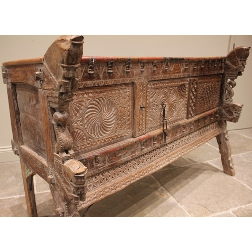 1030 - A Rajasthani hardwood dowry chest, 20th century, the geometric incised frieze applied with turned ha... 