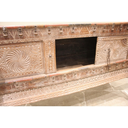 1030 - A Rajasthani hardwood dowry chest, 20th century, the geometric incised frieze applied with turned ha... 