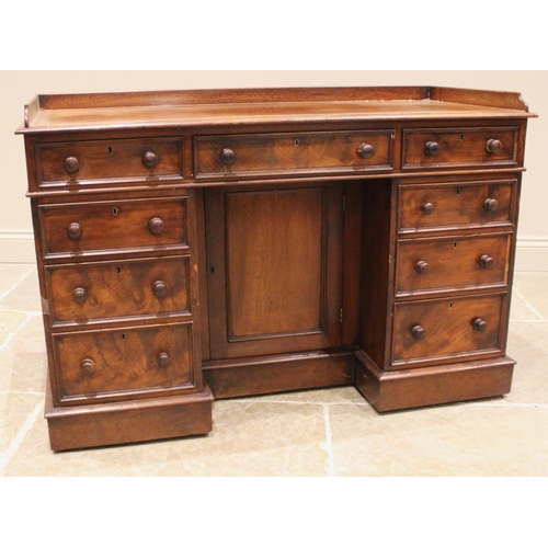 966 - A Victorian mahogany desk or dressing table, the three quarter galleried top over a central frieze d... 