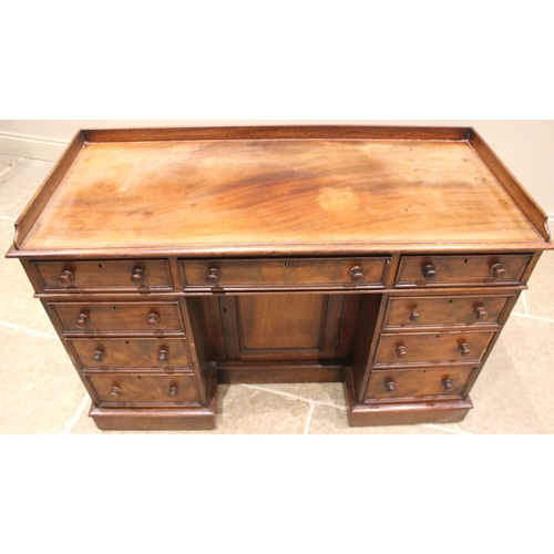 966 - A Victorian mahogany desk or dressing table, the three quarter galleried top over a central frieze d... 