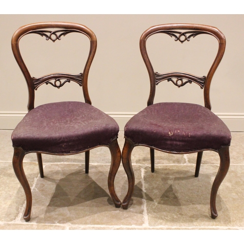 971 - A set of eight Victorian mahogany balloon back dining chairs, each with a curved rail back over a st... 