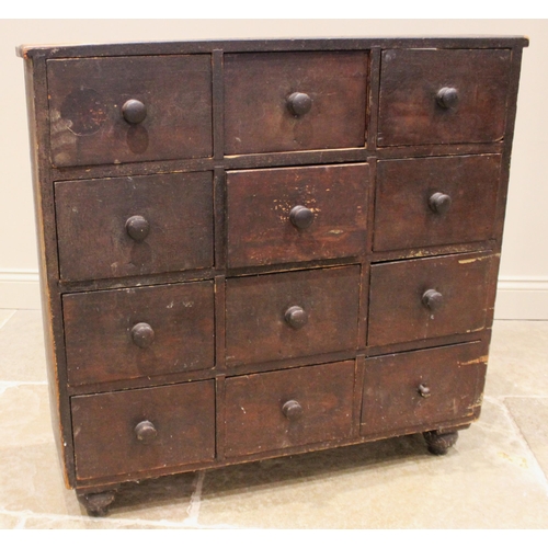 973 - A Victorian stained pine apothecary chest, formed with nine drawers, each applied with a hardwood dr... 