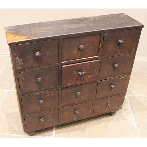 973 - A Victorian stained pine apothecary chest, formed with nine drawers, each applied with a hardwood dr... 