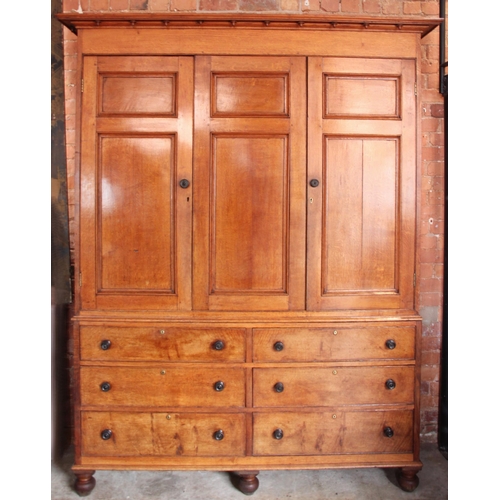 999 - A 19th century golden oak housekeepers cupboard, the oversailing cornice applied with acorn pendants... 