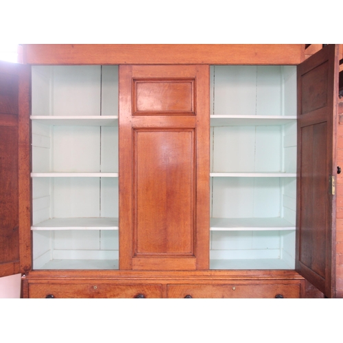 999 - A 19th century golden oak housekeepers cupboard, the oversailing cornice applied with acorn pendants... 