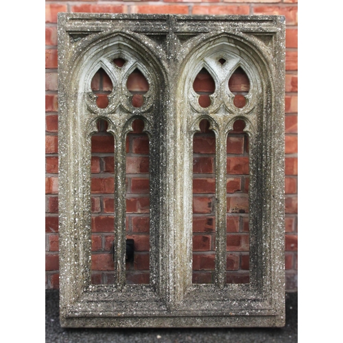 1118 - A reconstituted stone Gothic tracery window frame, with twin recessed arch shaped apertures, to a re... 